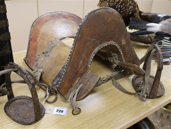 A Chinese inlaid wood saddle and a pair of iron stirrups, 19th century, 48cm long